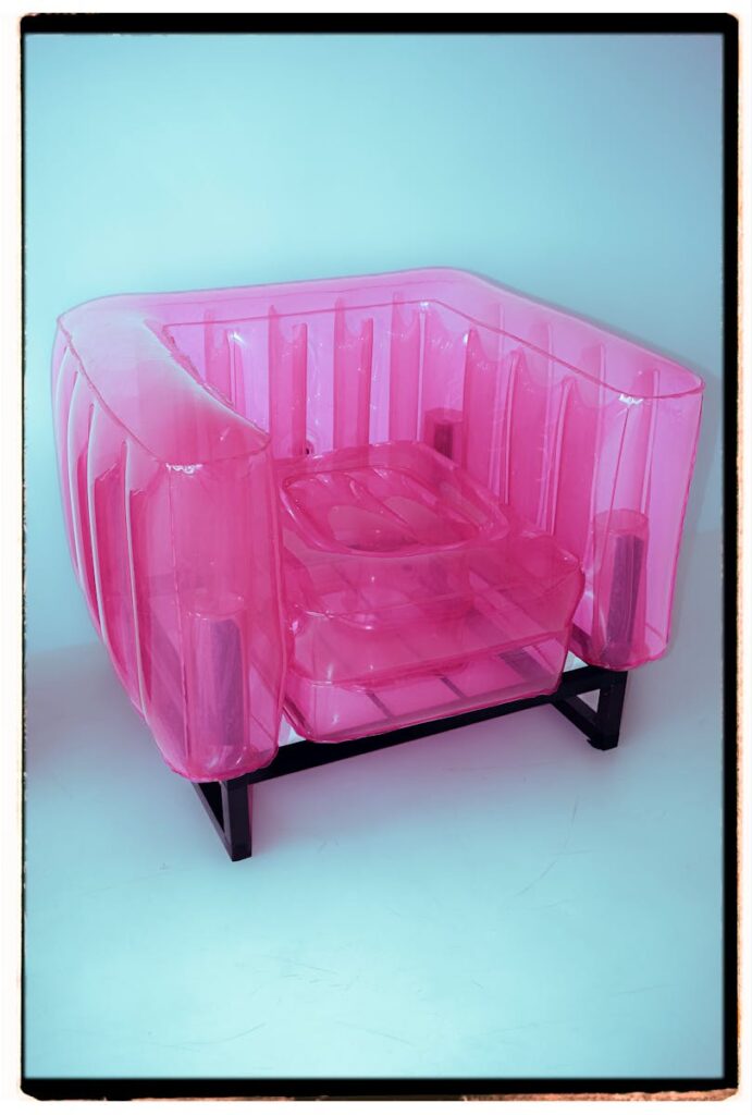 A stylish pink inflatable armchair showcasing modern design and comfort.