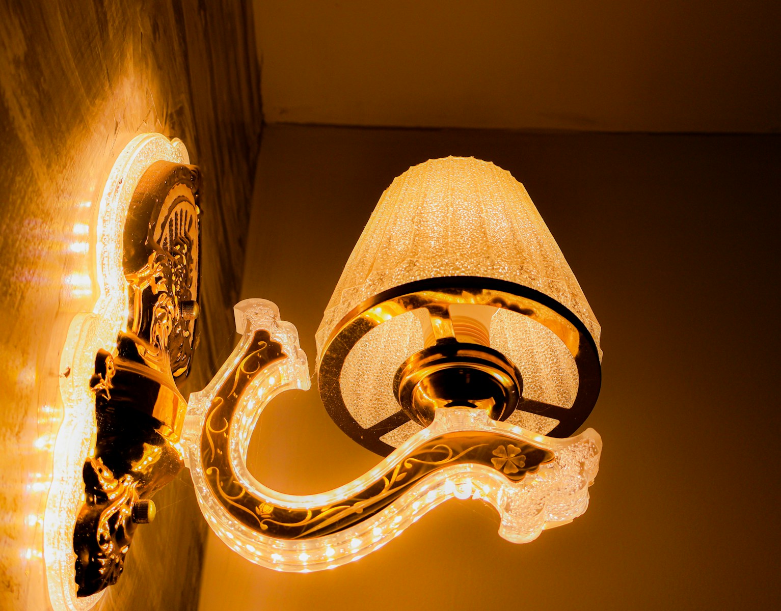 A decorative wall sconce emits warm, glowing light.