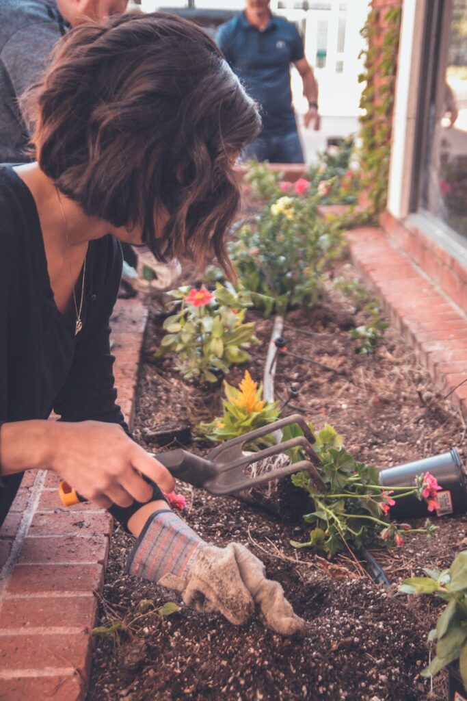 Photo by Kenny Eliason woman holding garden fork